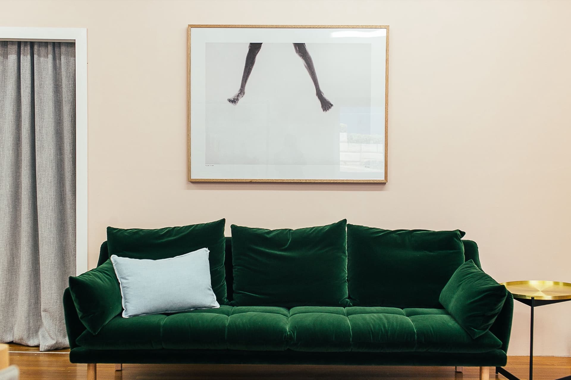 A green velvet sofa in a living room